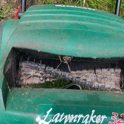 old but fully working lawn raker with collection box