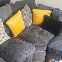 Grey corner settee with love chair, small tear unnoticeable on the back of the love chair as seen in picture.