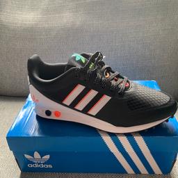 Black trainers with adidas logo on the back