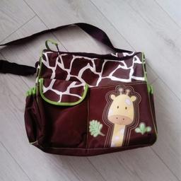 Giraffe and animal print baby changing bag. Elasticated pockets to the side, open topped pocket and velcro pocket to the front. Then to the back, there's a velcro pouch. The interior is green and benefits from a zipped pocket and small plastic waterproof bag attached. There is a green foldable changing mat liner inside. Immaculate and from a smoke and pet free home. Used once.