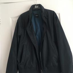Worn once bomber hooded jacket zip up elastic on sleeves and bottom to side zip pockets logo on left arm hood can b tucked away also has draw sting whit togs also has zip fully lined bluey green colour