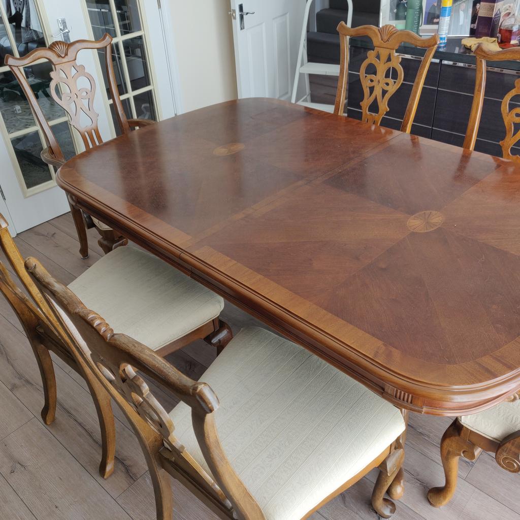 Beautiful dining table with 2 carvers and 4 additional chairs. Perfect for entertaining family and friends Table can be extended to seat upto 10 people with the addition of two leafs and 2 pull out drawers on either end . From a pet free and smoke free home. Collection only. Sold as seen. No refunds or returns.