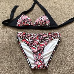 Brand new but no labels ladies  2 piece set bikini by Resort. The unmoulded  bra top is a halter neck with straps that you have to tie. The briefs are high leg
Size: UK 10
Colour: black, pink & white
Never been worn