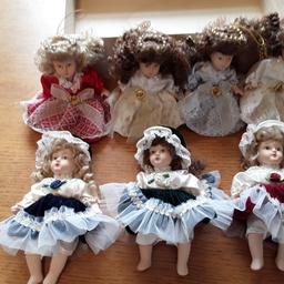 7 x 6in porcelain dolls.  4 have wings on,  3 susde dresses
