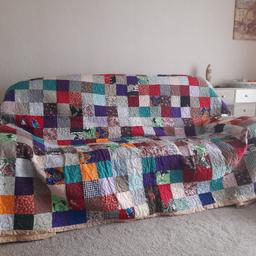 New large Patchwork and quilted cover. Ideal for king-size bed or to cover a three seater settee. Inside is Wadding for warmth. This is a one off piece of art. Can be washed. It could be made into two. Over 1000 hours of work. 12 foot 3 inches x 7 foot 6 inches