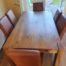 solid oak dinning table and 6 chairs. could do with re waxing. one of the chairs have been stapled pls see picture. 

collection from Huntington ws12 4pf