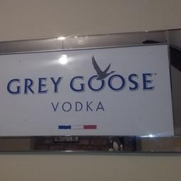 brand new Grey Goose Vodka mirror framed picture

approx 130cm x 70cm

as highlighted goose and writing, with crushed glass/crystal affect

blue, white, red and silver colours

can deliver locally

hanging fixtures on reverse

not posting as too heavy