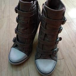 Limited edition by a.s.h.  High top trainer ankle boots with wedge heels. Side zip. Buckles. Gold. Pre-loved but plenty of life left.
Happy to adjust postage for multiple items.