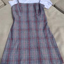 Hollister size medium (fit 8-10) checked pinafore and plain T-shirt. Pinafore check in black and red and white T-shirt. Side zip hidden fastening and shoestring adjustable straps.