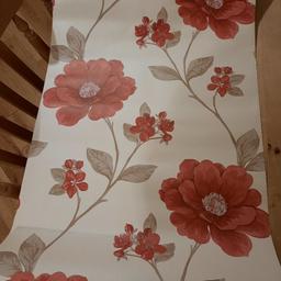 6 rolls wallpaper beige background red flowers. 2 rolls are open but still full. All are the same batch number