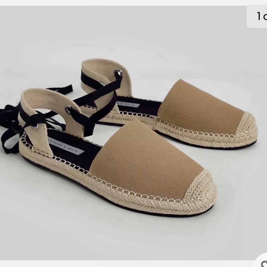These espadrille flats with a unique design are a must-have for your summer wardrobe. Featuring a dainty tie-around ribbon and woven fabric detailing, these flats are comfortable to wear all-day long. Made in a flattering camel colour to match a wide variety of looks, they give off a relaxed and casual vibe. Don these flats with a linen blouse and pants for a breezy summer look.