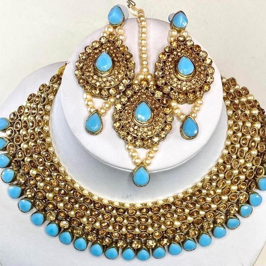 This beautiful 3 piece Choker Necklace, Earrings & Headpiece set is perfect for any Occasion. This amazing set is Gold Plated and filled with Bronze and Light Blue Stonework. As the Jewellery is made from Zinc this is a durable material which will not discolour or corrode.
Care Instructions: Keep away from Water, Body Lotions and Perfumes
