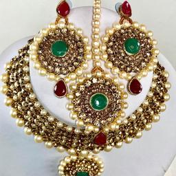 This beautiful 3 piece Choker Necklace, Earrings & Headpiece set is perfect for any Occasion. This amazing set is Gold Plated and filled with Bronze Green and Red stones. As the Jewellery is made from Zinc this is a durable material which will not discolour or corrode.
Care Instructions: Keep away from Water, Body Lotions and Perfumes