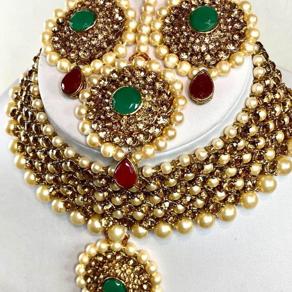 This beautiful 3 piece Choker Necklace, Earrings & Headpiece set is perfect for any Occasion. This amazing set is Gold Plated and filled with Bronze Green and Red stones. As the Jewellery is made from Zinc this is a durable material which will not discolour or corrode.
Care Instructions: Keep away from Water, Body Lotions and Perfumes