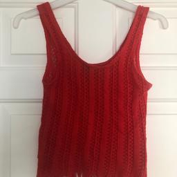 Orange/red vest top with raw fringe edging, size 6 by Topshop.
Only worn once so still in good condition.