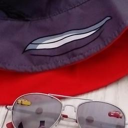 Immaculate child's reversible bucket hat with 'Disney's cars' design. Has never been worn. The bucket hat is for a toddler/nursery aged child and is red one side and grey the other, but doesn't have a label inside due to it being reversible. The mirrored style sunglasses, also in cars design, are included in the price. From a smoke free, pet free home. Collection only please.