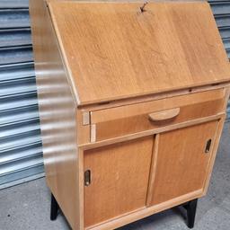 Drop leaf writing bureau by 'styles & Mealing ltd
Light Wood Drop front Writing Desk
Home Computer Desk
Childs Desk with cupboard and drawers
Used but still good strong condition.
Small piece of vaneer has come off the front of the drawer..see pics
leather writing pad will need replacing or covering.

Free delivery in Scunthorpe
Collection welcome

Welcome to arrange your own courier.
Willing to post at buyer's risk please pass on your postcode and I will try check prices.