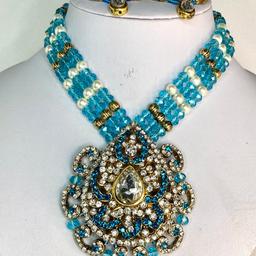 This elegant necklace set will make you turn heads at any occasion.

This Beautiful 2 piece Necklace and Earrings set is perfect for any Occasion. This amazing set is Gold Plated and filled with Blue Stonework & Pearls . As the Jewellery is made from Zinc this is a durable material which will not discolour or corrode.
Care Instructions: Keep away from Water, Body Lotions and Perfume