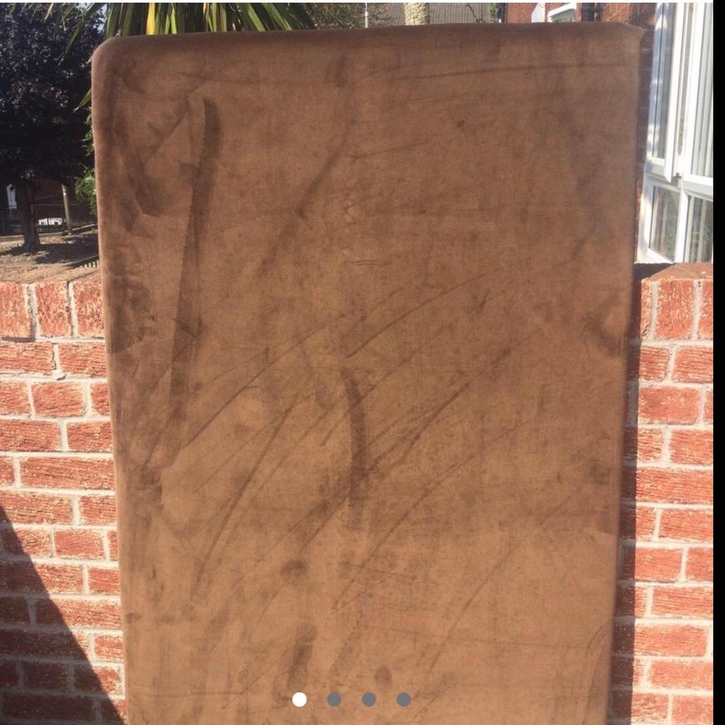 Large brown velvet double bed headboard , it screws to the wall . It was handmade . Still in a good condition . You could turn it upright too maybe for a single bed but the double goes oblong .