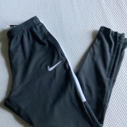 Grey jogger bottoms with white tick and side