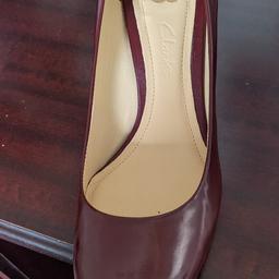 these are a lovely wine colour shiny leather. brand new never worn in box