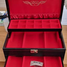 large lockable black jewellery box with red fabric inner. Is old but hardly used so still in good condition.
