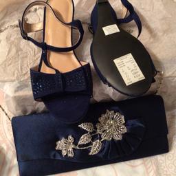 Ladies sandals and clutch bag sandals size 6 and bag has a removable shoulder chain in silver colour to match detail on bag sandals have a wedge heel never worn