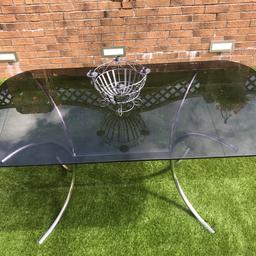 Beautiful and stylish mid century vintage 6 seater dining table with a chrome based pedestal. Circa 1960s / 70s

Smoked plate glass table top, which is attached by rubber suckers to the base.

In good vintage condition.

The frame is sturdy and structurally sound .
The glass has a slight chip to the underside edge of the top and there are odd scratches from use / gradual wear and tear.

The chrome shows an element of pitting due to wear and tear / age.

Hi L - 152 cm, H - 72 cm , W - 81 cm.

This would be a great addition to a lovely mid century, vintage home.

From pet / smoke free home.

Collection Only - HD3