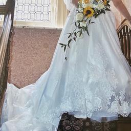 I’m selling a beautiful off white wedding dress the dress is called you are everything to me and comes with crystal flower scroll edge veil it also comes with in the price the shoes size 4 and pearl an earring set which are still sealed. you could get away with a size 14/16 I still have the receipt that comes with the dress. also it as a very long beautiful trail. check items out it’s a shame to waist a beautiful dress when someone else can wear the beauty