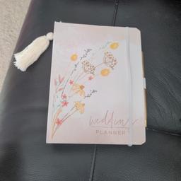 brand new Next wedding planner with dividers for different sections of planning.

come with pen