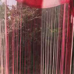 Two string curtain panels . One shown open they are about 72 drop but suppose could be cut to fit. Three colours red pink and white silky thread. Loads of movement look very pretty up . Like new .