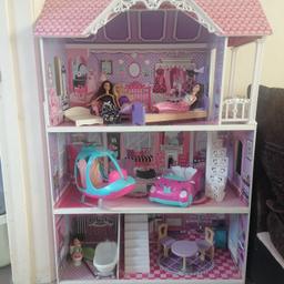 Selling dolls house with dolls and furnite plus helicopter and car