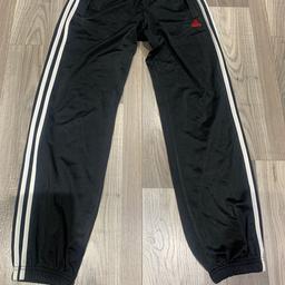 Black adidas tracksuit bottom with white stripes and red logo has been used a few times and in very good condition (size 13-14 )