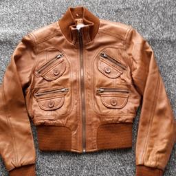 Tan soft leather jacket with a front zip fastening & 2 front & 2 side pockets. It is a size 10 and is fully lined by top leather designer ASHWOOD