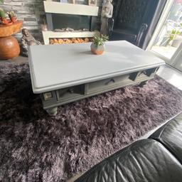 A really chunky wooden coffee table. With 3 draws that push through to other side so plenty of storage size H 18 inch. D 30 inch. L55 inch. So quite large.