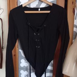 Long sleeve black ribbed tie up bodysuit with popper fastening to crotch 

Tried on so no tags, as new 

Collection m23 brooklands 
Can deliver to m23 for small fee 

check out my other items having a clear out