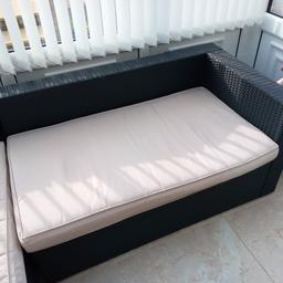 Rattan furniture and cushions - suitable for conservayory or garden usage. L shape -  Black with bottom and back cushions. Sizes are 204cm long by 146cm wide (77cm ar shortest point). height of 62cm. splits onto 2 pieces. collection only