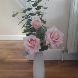 approx 30cm high white sturdy vase with a collection of false flowers in pink with foliage. Only selling as we are changing colour scheme. Vase has a nice weight to it.