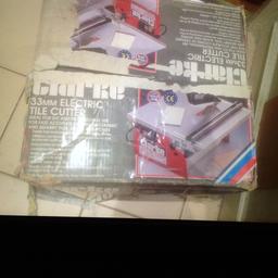 Electric Clark 33 mm tile cutter for wall and floor tiles includes two different sized trays in good working order comes in it’s original box with instructions.