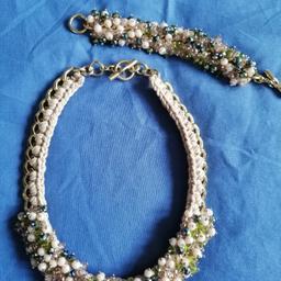 Vintage Handmade in Italy, Parure Set, necklace and bracelet.

Steel chain, hand sewn and stone applied by hand. Different green and cream stone shade. Used a couple of times. Perfect for occasions.