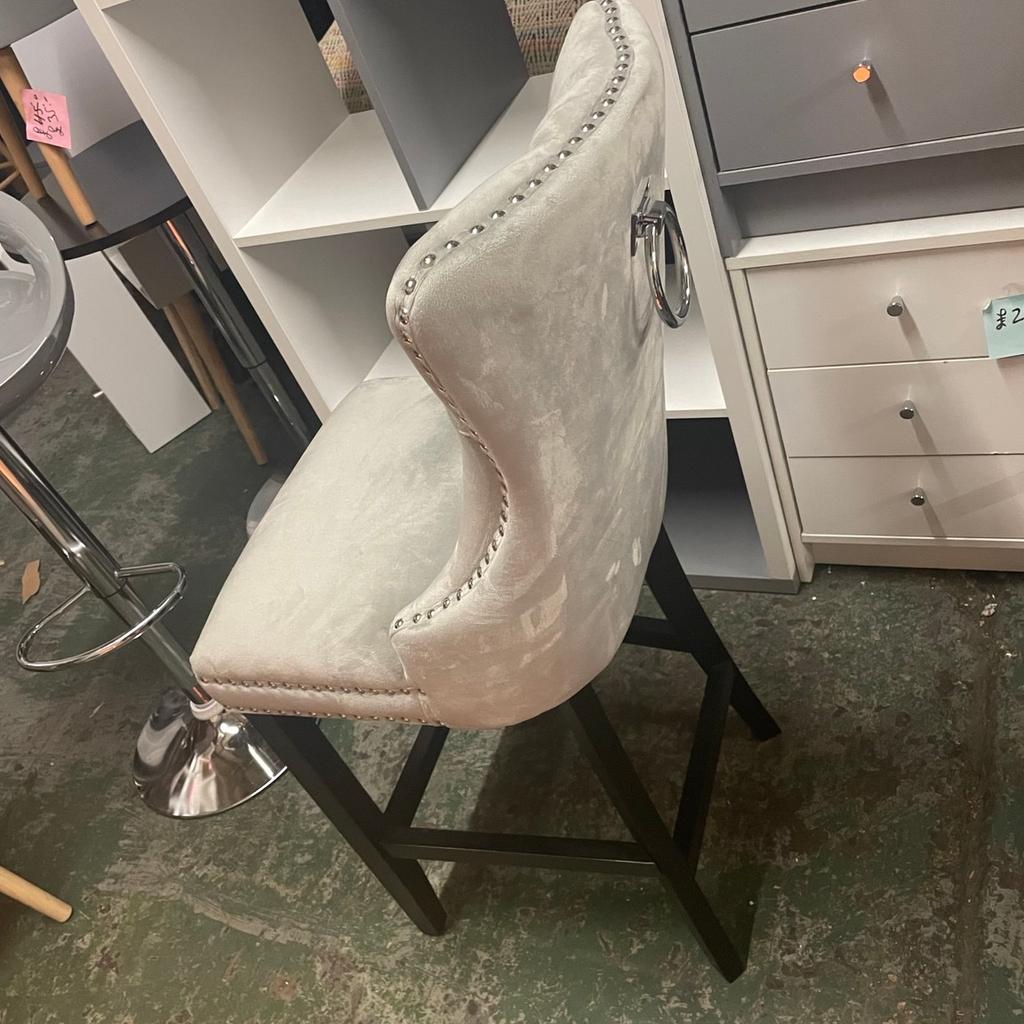 New Fully Assembled

Who says bar stools need to be basic? We've given this plush Princess Stud bar stool plenty of indulgent flourishes to make it fit for. . . Well a princess! We're talking studded detailing, tufted buttoning and even a decorative ring pull back!
Finished in luxurious light grey velvet style with a soft sheen appearance, this chair is perfect for leisurely late-night drinks. With a rubberwood frame and legs, it's also a sturdy choice. With this graceful stool taking pride of place, your breakfast bar will never look so good!
Chair:
•	1 chair supplied.
•	Size H103.5, W44.5, D55cm.
•	Seat height 68.5cm.
•	Foot rest.
•	Rubberwood frame with rubberwood legs.
•	Velvet seat pad.
•	Max user weight per chair 130kg.
•	Individual chair weight 8.6kg.
•	Wipe clean with a soft cloth.
