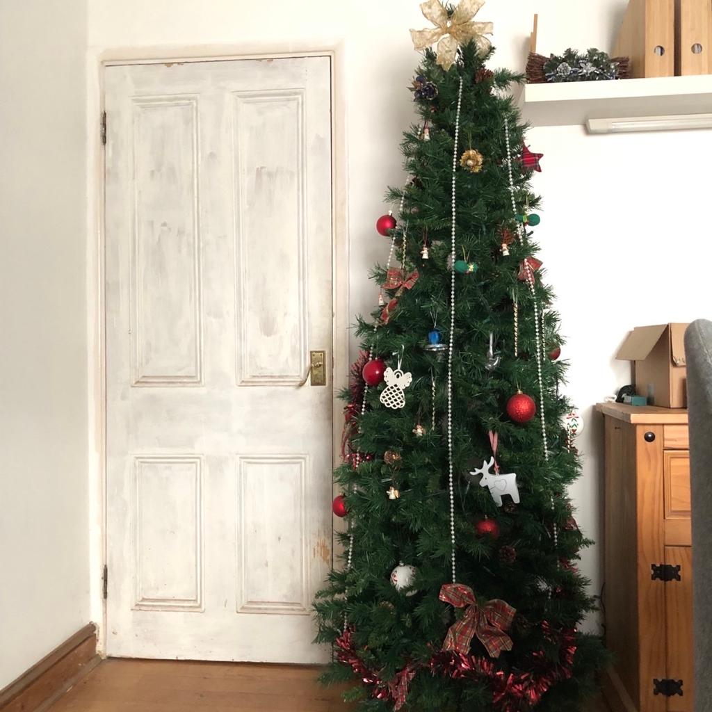 A good quality artificial Christmas tree for sale. It can be sold assembled as pictured or disassembled.

No missing branches and a sturdy base. The tree is a standard door height.

Can be sold with some decoration (for extra cost). The selling price shown here is for the tree without any decorations.

No box but I can provide a large IKEA bag and a smaller bag.

Collection only please.