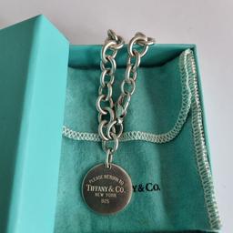 In good preloved condition and retired Tiffany&Co. Tiffany RTT disc tag bracelet. Pouch and box. 7.5" length - end to end. Trusted seller, UK based. See my profile for a large variety of T&Co. items. Thank you.