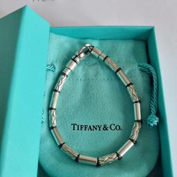 In good condition and retired Tiffany&Co. Tiffany Zig Zag Hematite and Silver bracelet (very hard to come by). Pouch and box. 7.375" length - end to end. Trusted seller, UK based. See my profile for a large variety of T&Co. items. Thank you.