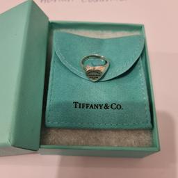 In good preloved condition Tiffany&Co. Tiffany RTT heart signet ring. Size 5 1/2 - UK K 1/2 (please see all the pictures). Pouch and box. Trusted seller, UK based (retails for £430). See my profile for a large variety of T&Co. items. Thank you.