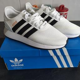 Adidas N-5923 trainers are white and black. They are a size 4.5. They are brand new with the box.