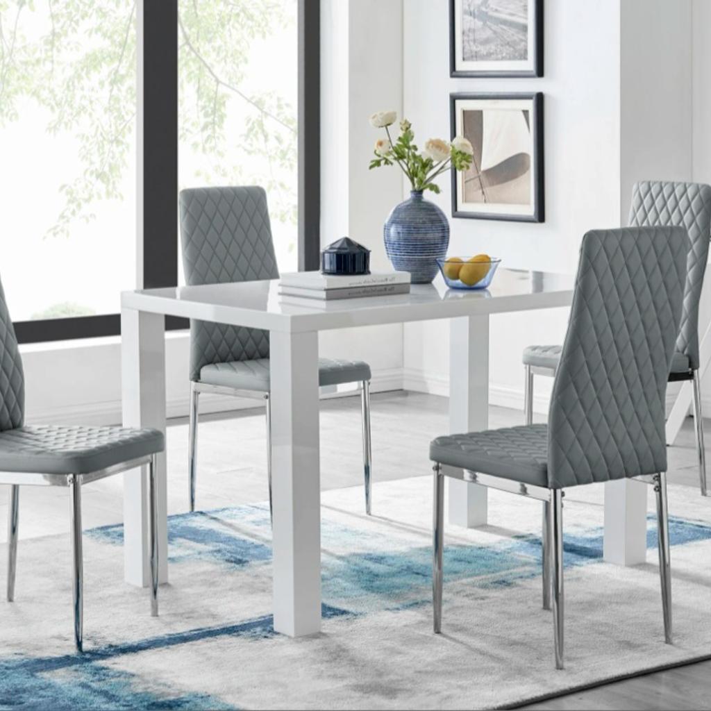 This White High Gloss Small Dining Table with 4 PU Dining Chairs with Grey Frame Set add a Modern Touch In Your Home.

The dining chairs are in soft-covered Faux Leather PU and have a cushioned back and seat in a curved design for added comfo7rt. The chrome metal frame adds the perfect finish. The chairs are nice and light and can be lifted easily. To protect your floor and to avoid noise, the chair legs are equipped with plastic caps.

Table Dimensions: H 75 X W 120 X D 70cm

Comfortably Seats 4 people

Assembly required

Delivery available