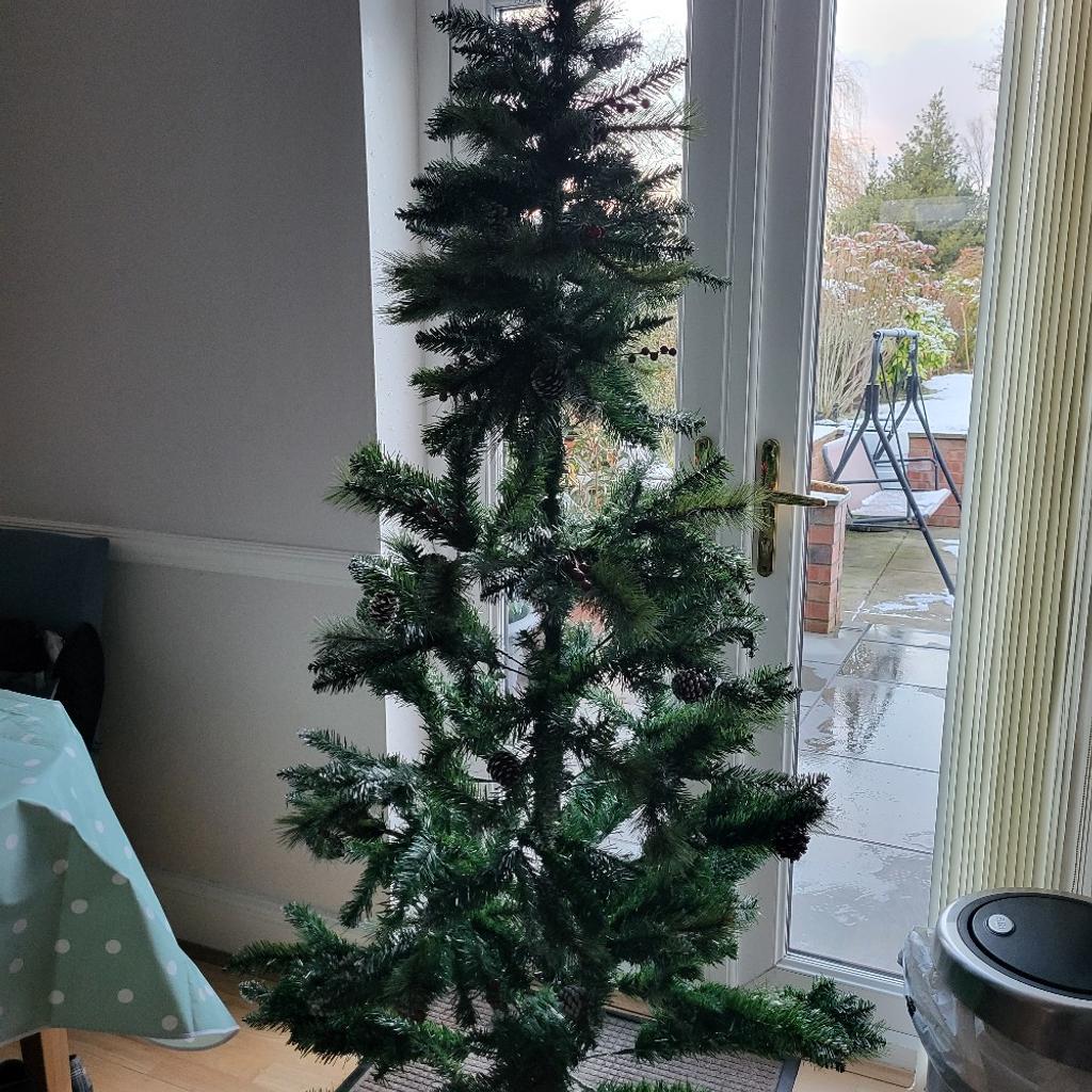 brand new tree, lifted from box to take photos , needs to be spread out more cone and berries attached