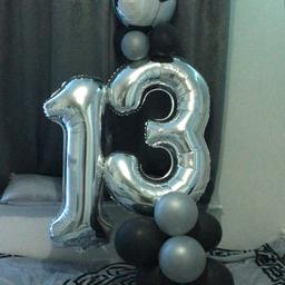 -Big “13” balloon with grey + black normal sized balloons on bottom + top.
- Also has a football balloon on top