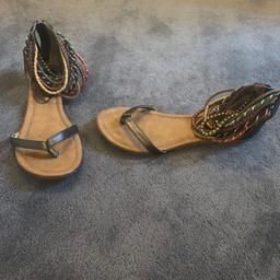 Ladies Aldo sandals in brown / bronze colours with zip up backs and several beaded strands around the ankle. Lovely sandals, fab condition.

If postage is required then the postage cost will be added.